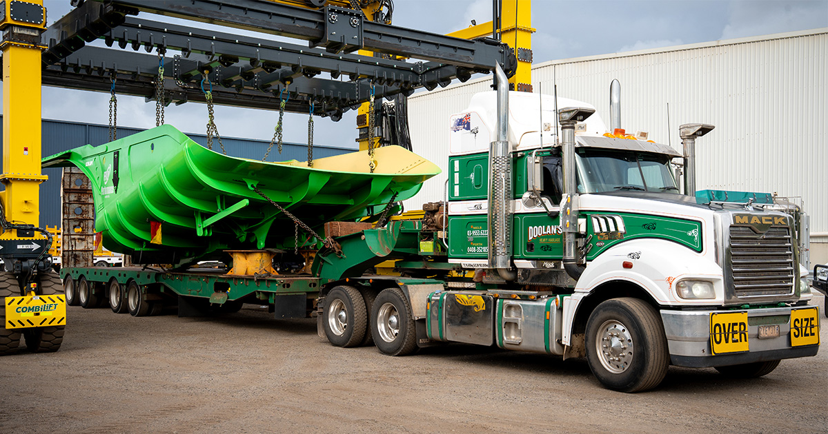 Performance Mining's distinctive green Hercules truck bed being loaded by CombiLift onto truck leaving Schlam's Forrestfield facility